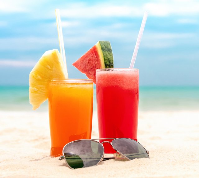 Colorful refreshing cold tropical fruit juice drinks in summer b